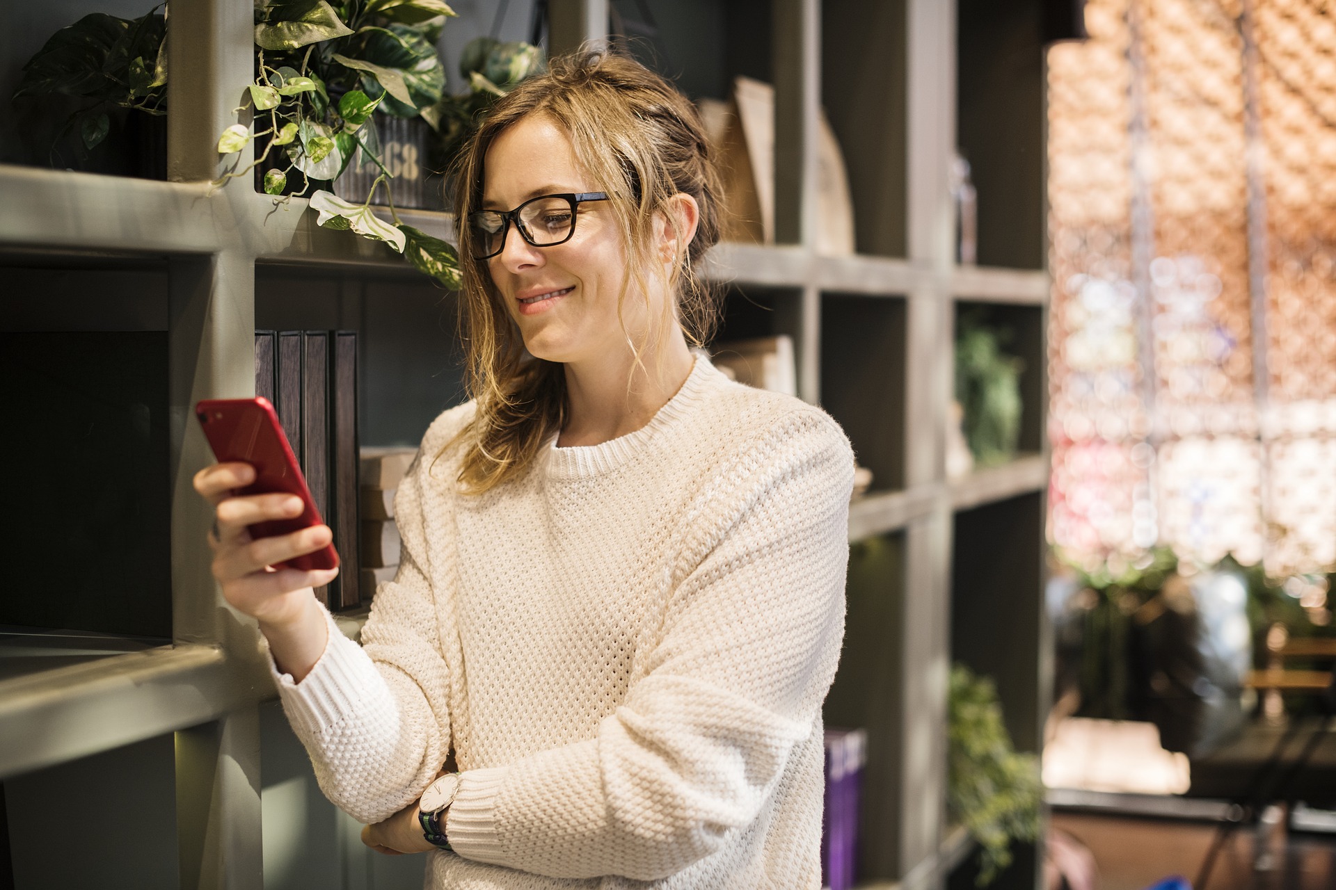 Woman looking at smart phone and smiling