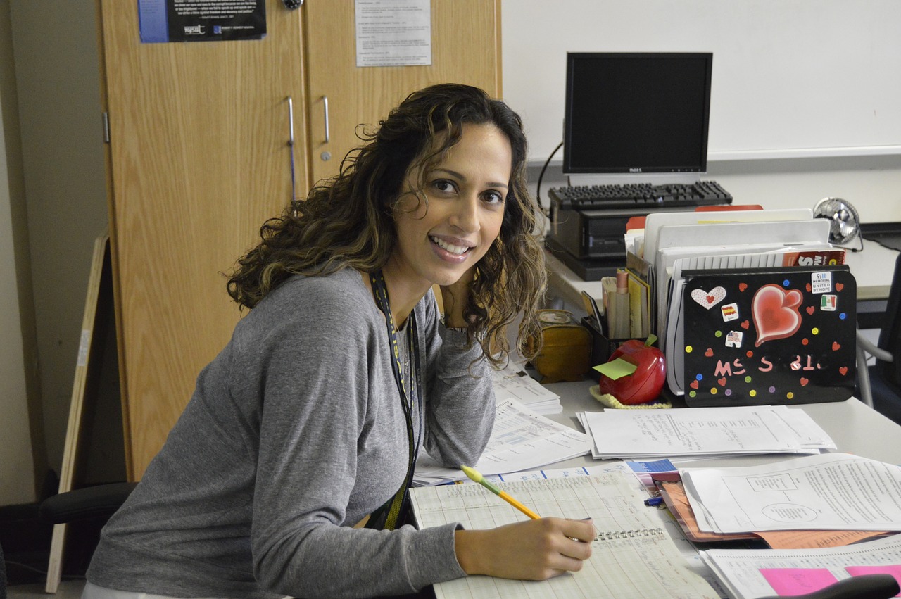 Woman teacher sitting at her desk.